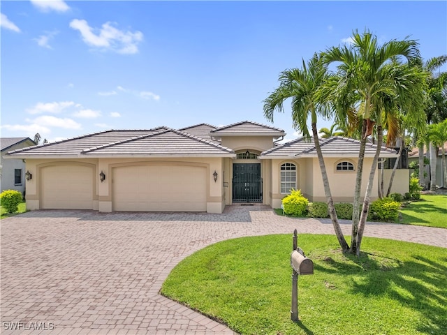 view of front of house with a front lawn and a garage