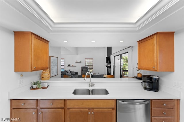 kitchen featuring kitchen peninsula, a tray ceiling, crown molding, sink, and dishwasher