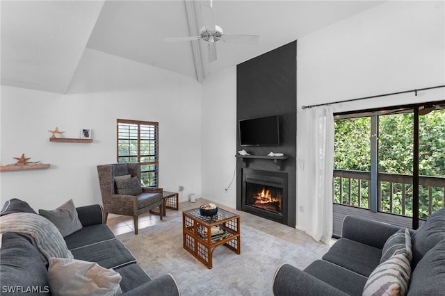 living room featuring ceiling fan, a large fireplace, light tile patterned flooring, and high vaulted ceiling