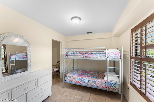 bedroom featuring light tile patterned flooring