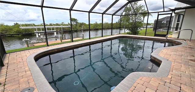 view of pool with a lanai, a dock, a patio area, and a water view