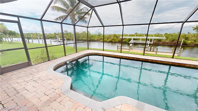 view of pool featuring a patio area, a boat dock, a water view, glass enclosure, and a yard