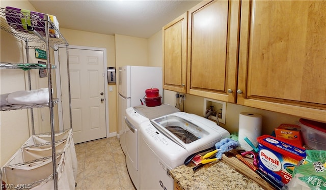 laundry area featuring cabinets and washer and dryer