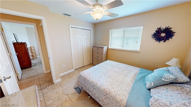 tiled bedroom featuring a closet and ceiling fan