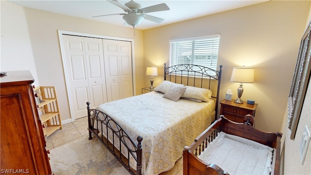 bedroom featuring ceiling fan, a closet, and light tile patterned floors