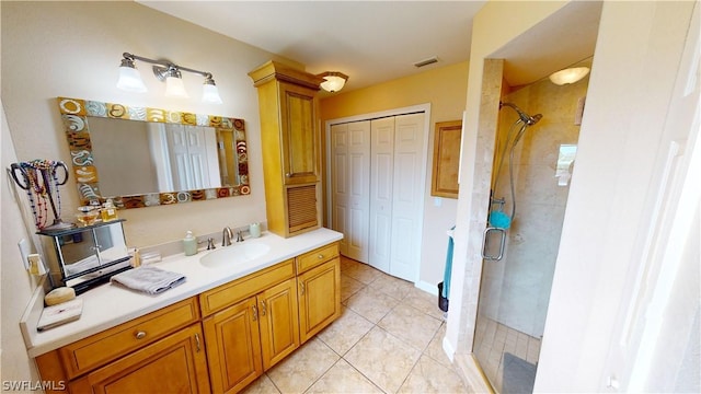 bathroom featuring vanity, tile patterned flooring, and a shower with door