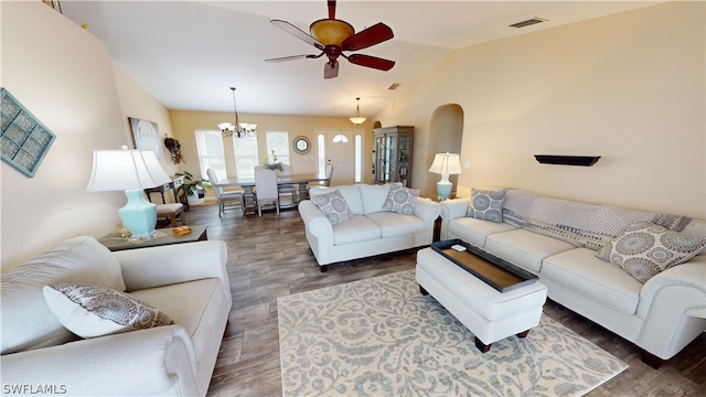 living room featuring dark wood-type flooring, lofted ceiling, and ceiling fan with notable chandelier