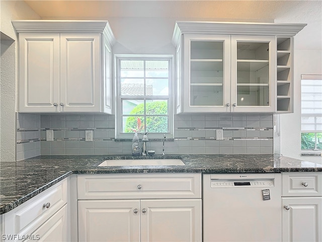 kitchen featuring white dishwasher, sink, and white cabinetry