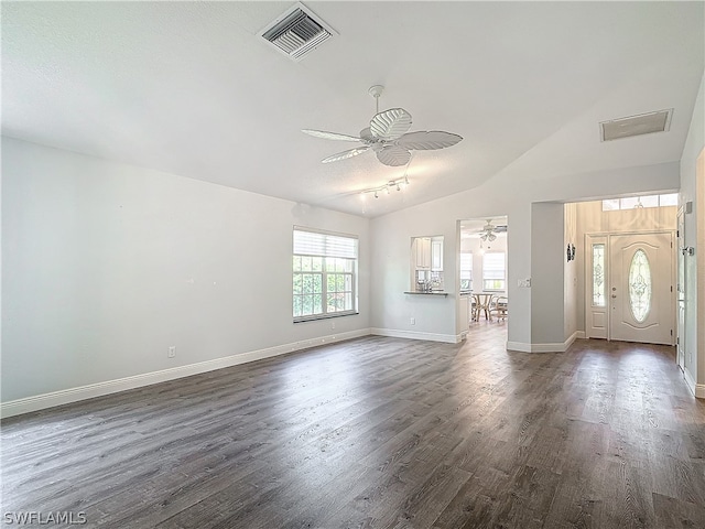 interior space featuring lofted ceiling, ceiling fan, dark hardwood / wood-style flooring, and a textured ceiling