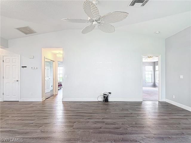 empty room featuring lofted ceiling, ceiling fan, dark hardwood / wood-style flooring, and a textured ceiling