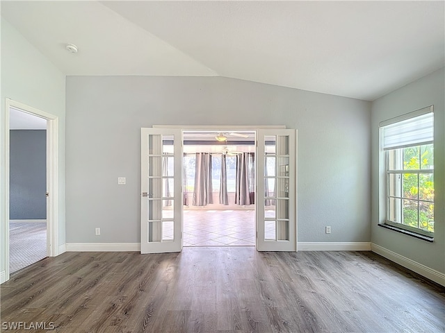 unfurnished room with wood-type flooring and vaulted ceiling