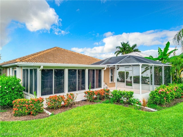 back of property featuring a yard and a lanai