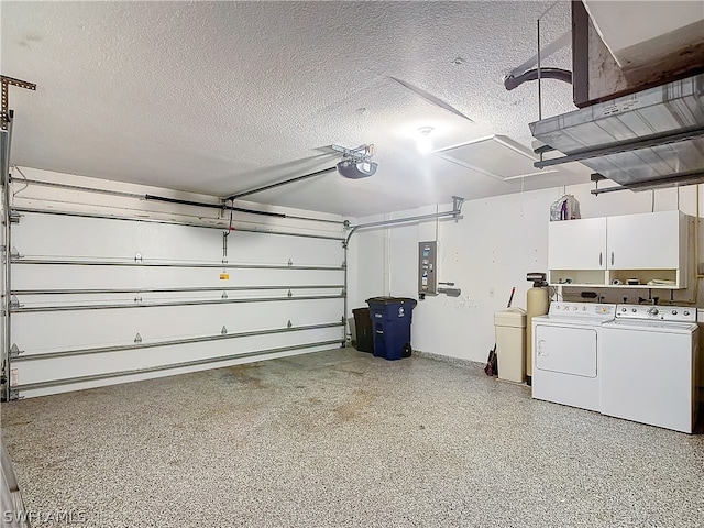 garage with independent washer and dryer and a garage door opener