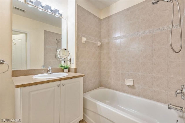 bathroom featuring vanity and tiled shower / bath combo