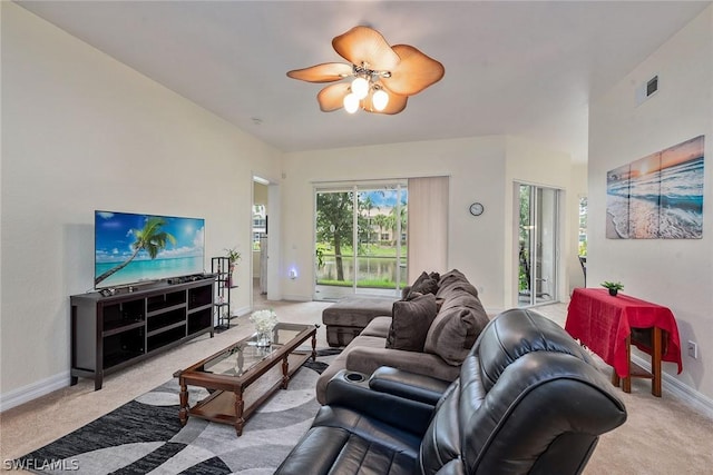 carpeted living room featuring ceiling fan