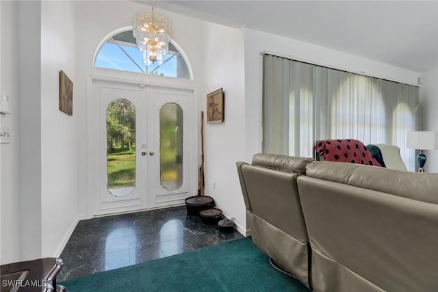 foyer entrance with french doors and a notable chandelier