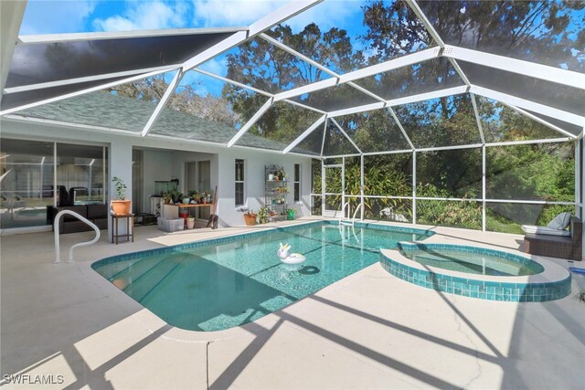 view of swimming pool featuring glass enclosure, a patio area, and an in ground hot tub