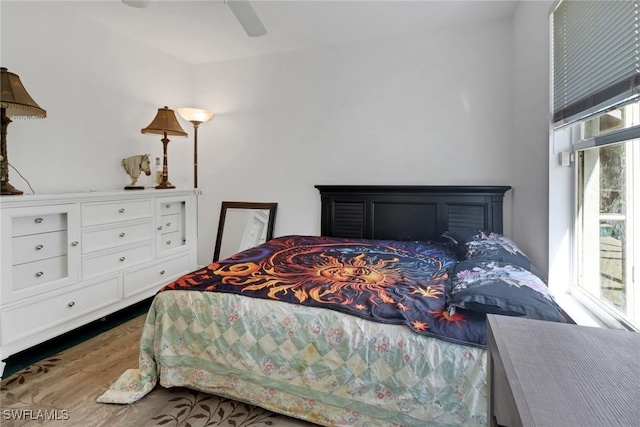 bedroom featuring multiple windows and ceiling fan