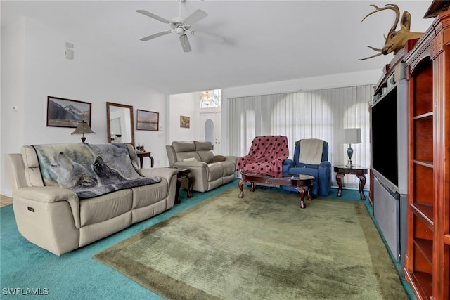 living room with ceiling fan and dark carpet