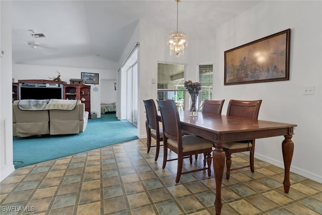 dining room with vaulted ceiling, a healthy amount of sunlight, and ceiling fan with notable chandelier