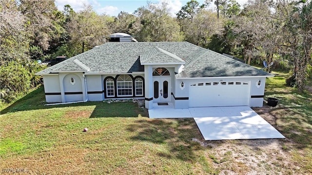 view of front of home with a garage and a front lawn