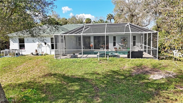 rear view of house featuring a yard and glass enclosure