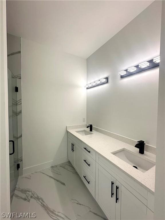 bathroom with vanity and a shower with door