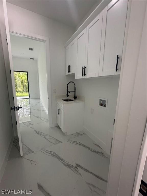 laundry room featuring cabinets, sink, and washer hookup