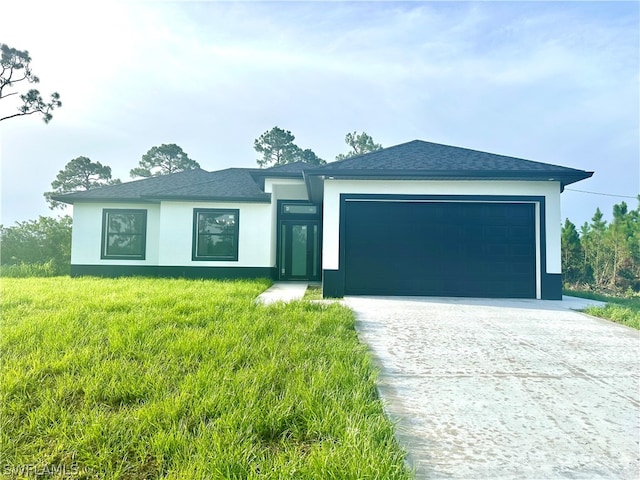 view of front of home with a garage and a front yard