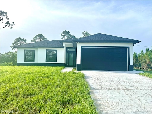 view of front of property featuring a garage and a front lawn