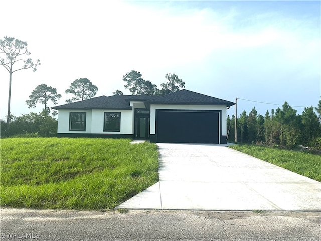 view of front facade with a garage and a front yard