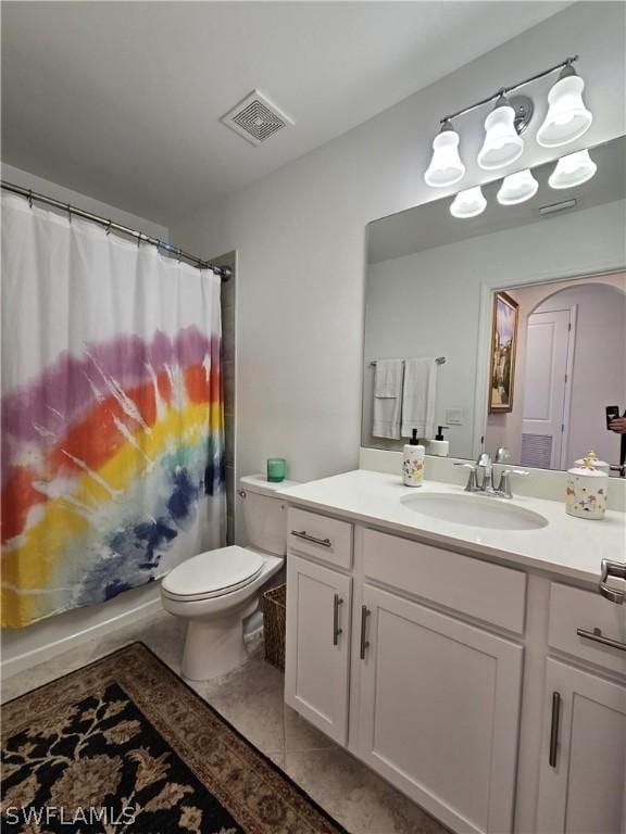 bathroom featuring tile patterned flooring, vanity, and toilet