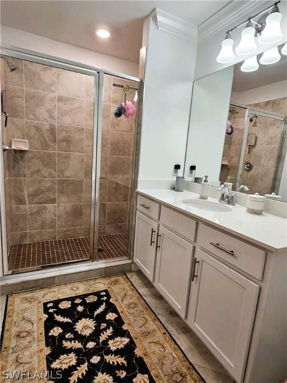 bathroom featuring an enclosed shower, vanity, and ornamental molding