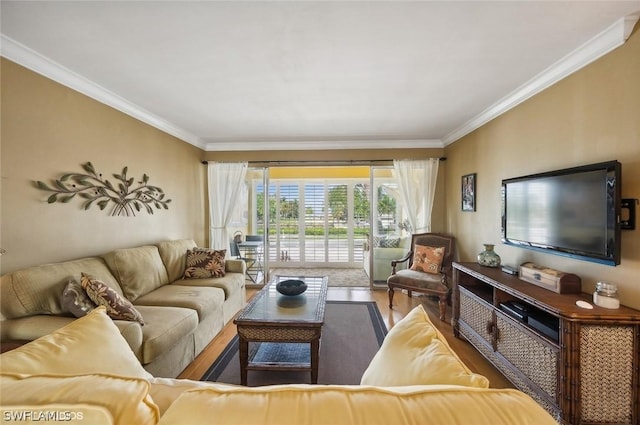 living room featuring wood finished floors and crown molding