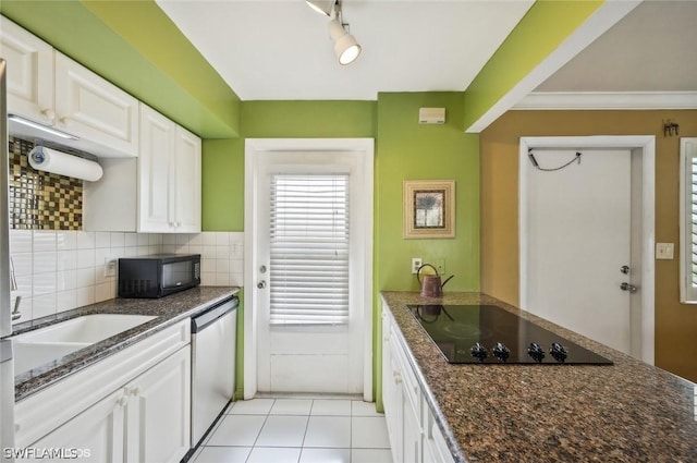 kitchen featuring tasteful backsplash, dark stone counters, black appliances, white cabinetry, and light tile patterned flooring