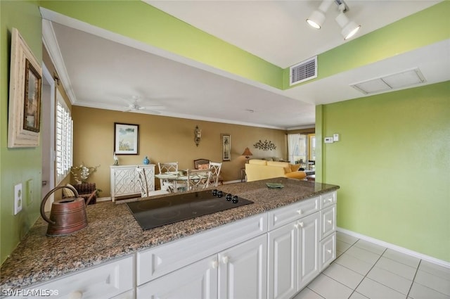 kitchen with a healthy amount of sunlight, white cabinets, visible vents, and black electric cooktop