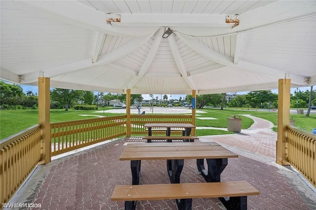 view of property's community with a lawn and a gazebo