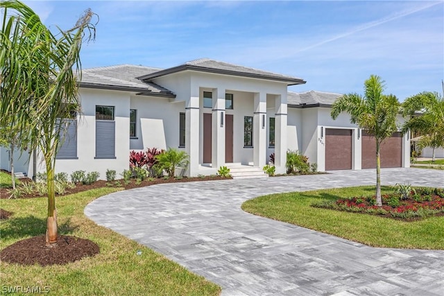 view of front of house featuring a garage and a front lawn