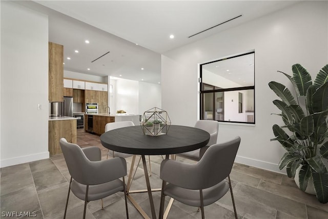 dining room with concrete flooring and sink