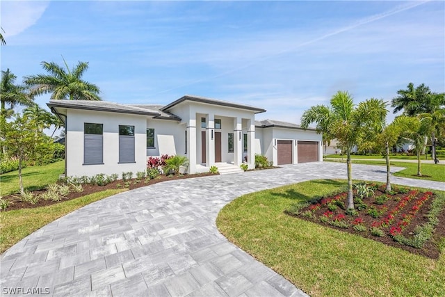 view of front of house featuring a garage and a front yard