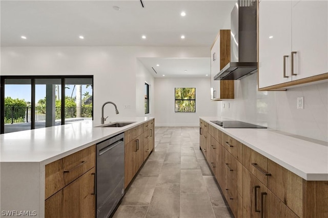 kitchen featuring dishwasher, sink, wall chimney range hood, a spacious island, and black electric stovetop