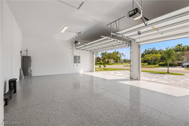 garage featuring electric panel, a garage door opener, and water heater