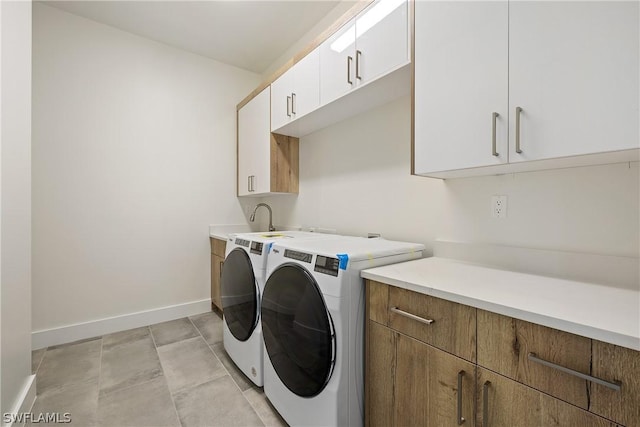 washroom featuring cabinets and independent washer and dryer