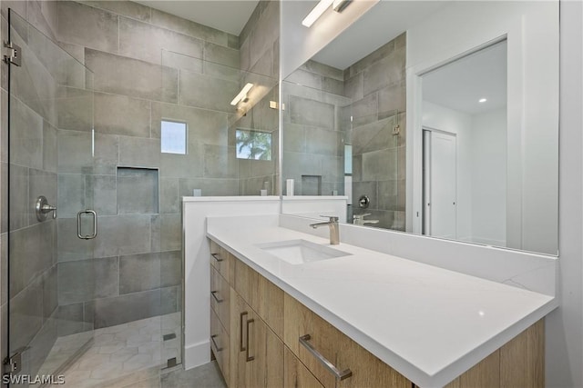 bathroom featuring vanity and an enclosed shower