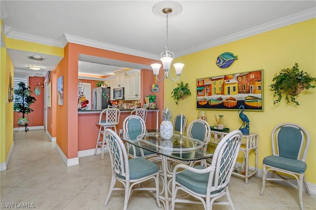 tiled dining area featuring crown molding and an inviting chandelier