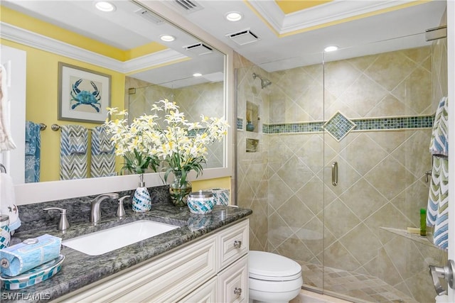 bathroom featuring a tray ceiling, vanity, crown molding, and walk in shower