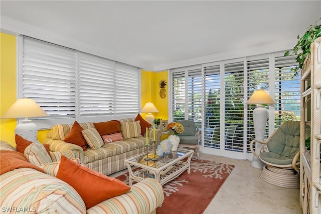 living room with light tile patterned floors and ornamental molding