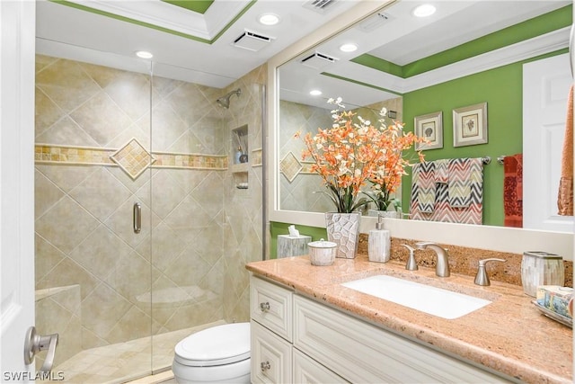 bathroom with an enclosed shower, vanity, ornamental molding, and toilet