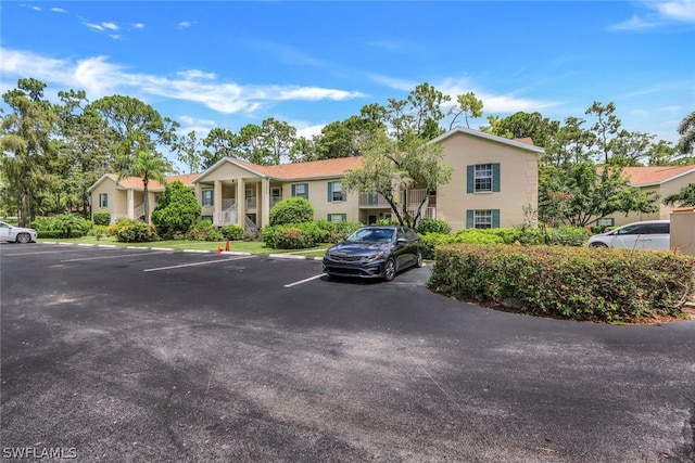 view of property featuring uncovered parking