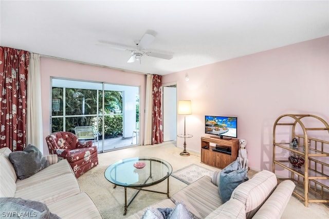 carpeted living room with ceiling fan